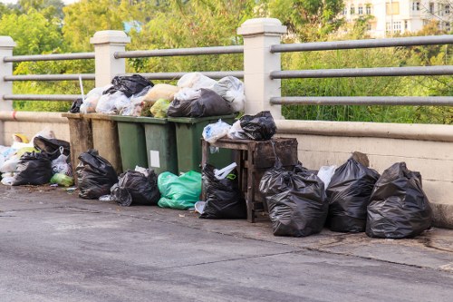 Rubbish removal truck onsite in Raynes Park