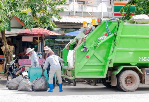 Man and van team loading furniture in a narrow street